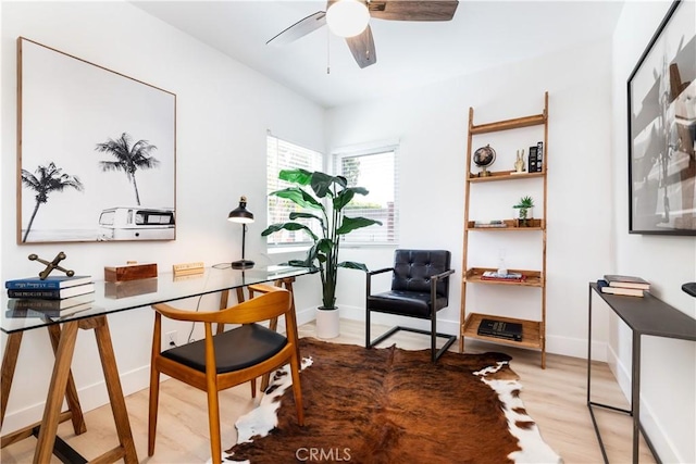 office space with light hardwood / wood-style floors and ceiling fan