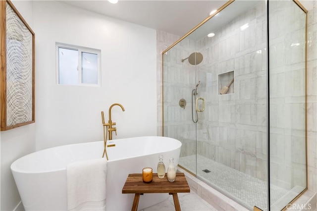 bathroom featuring separate shower and tub