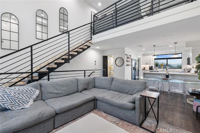 living room with a high ceiling and hardwood / wood-style floors