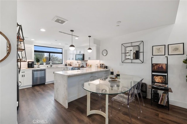 kitchen featuring white cabinetry, sink, hanging light fixtures, kitchen peninsula, and stainless steel dishwasher