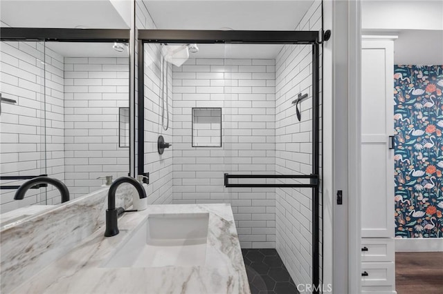 bathroom with an enclosed shower and vanity