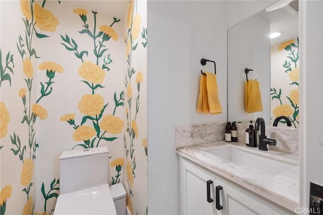 bathroom with toilet and vanity