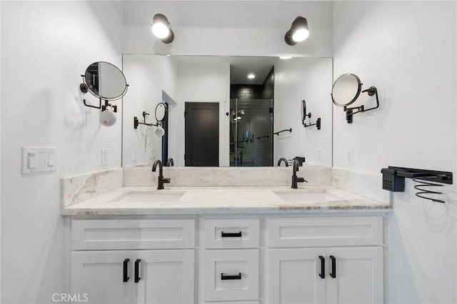 bathroom featuring walk in shower and vanity