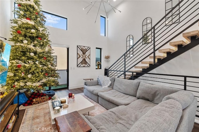 living room featuring hardwood / wood-style flooring and a towering ceiling