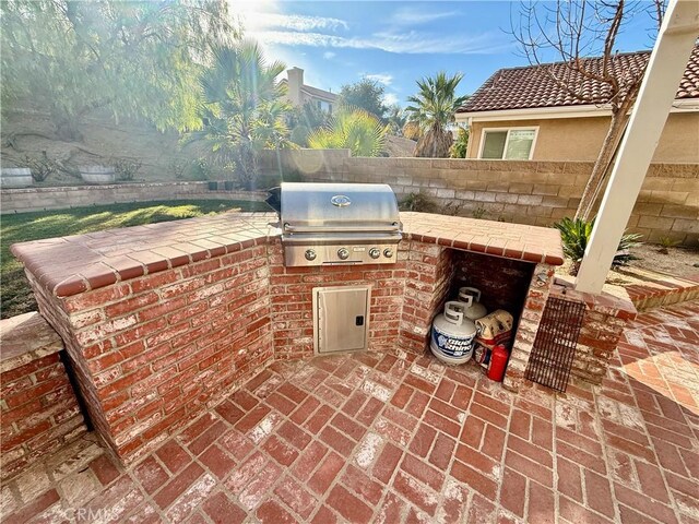 view of patio / terrace featuring a grill and exterior kitchen