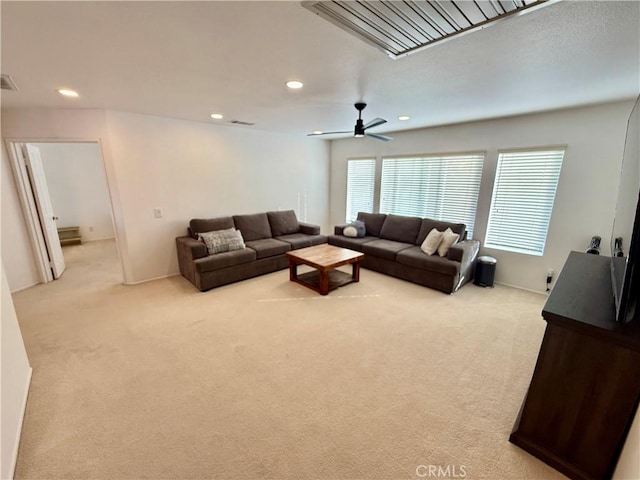 carpeted living room with ceiling fan