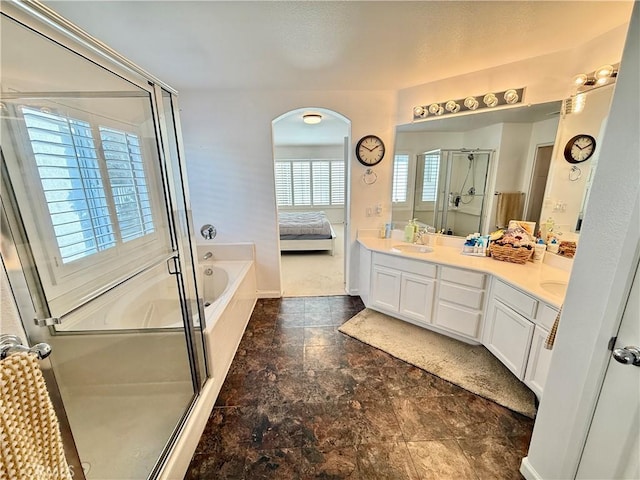 bathroom featuring vanity and shower with separate bathtub