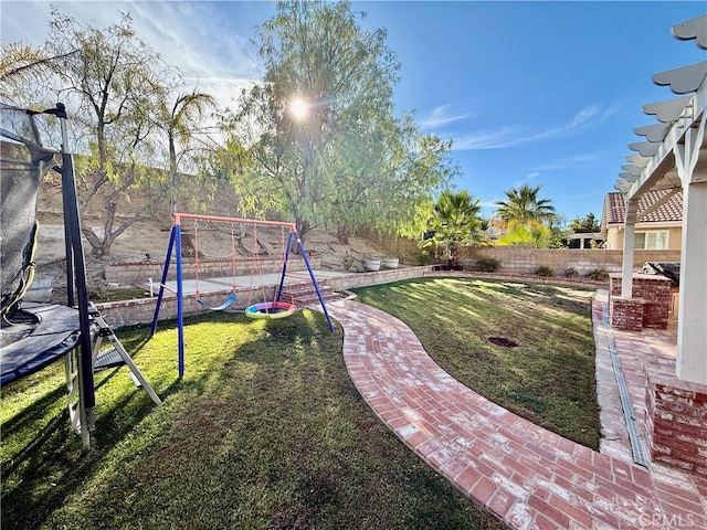 view of yard featuring a playground and a trampoline