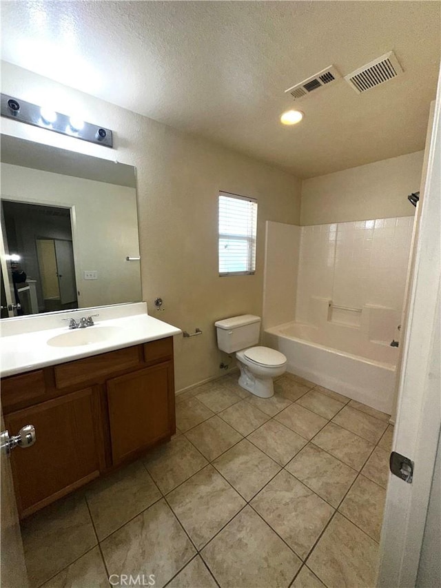 full bathroom featuring tile patterned floors, a textured ceiling, toilet, vanity, and shower / bathing tub combination