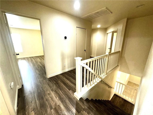 hallway with dark hardwood / wood-style flooring