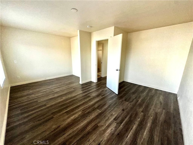 empty room featuring dark hardwood / wood-style flooring