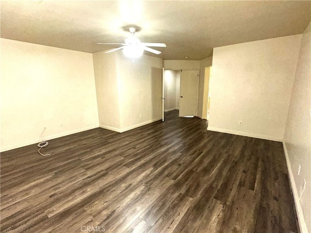 empty room featuring ceiling fan and dark hardwood / wood-style flooring