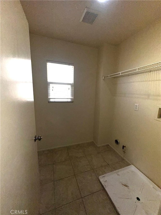 laundry room with gas dryer hookup, washer hookup, and tile patterned floors