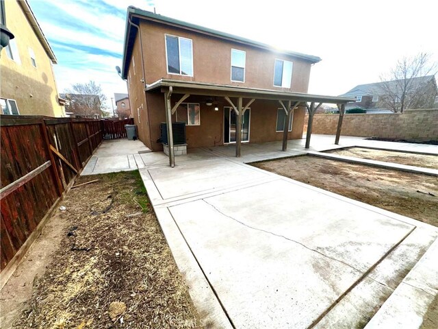 back of property with a patio area and central AC unit