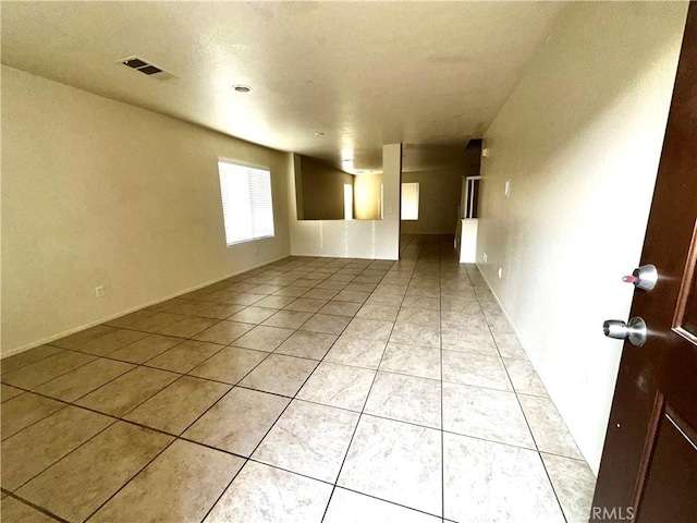 unfurnished room with light tile patterned floors