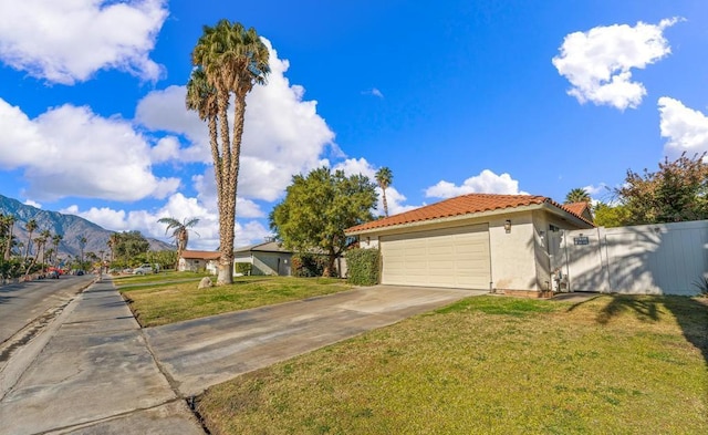 view of front of home with a front yard and a mountain view