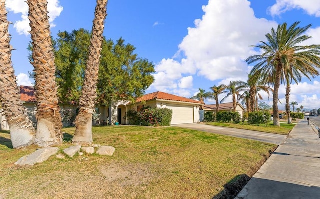 mediterranean / spanish home with a garage and a front yard