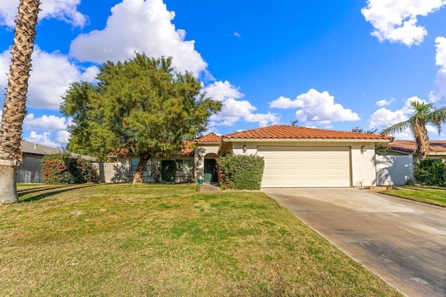 view of front of property with a garage and a front lawn