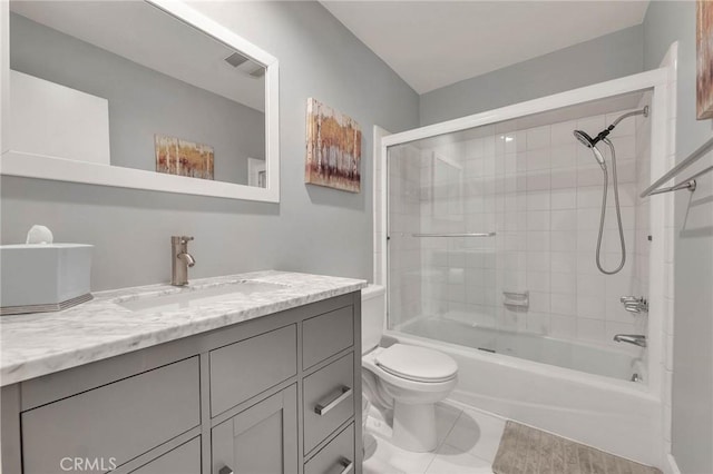 full bathroom featuring toilet, vanity, tile patterned flooring, and tiled shower / bath