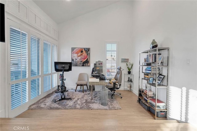 office space with lofted ceiling and light hardwood / wood-style floors