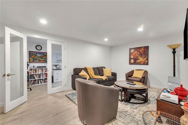 living room featuring french doors and light hardwood / wood-style flooring