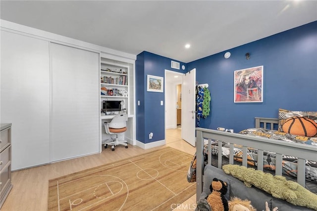 bedroom with hardwood / wood-style flooring and a closet