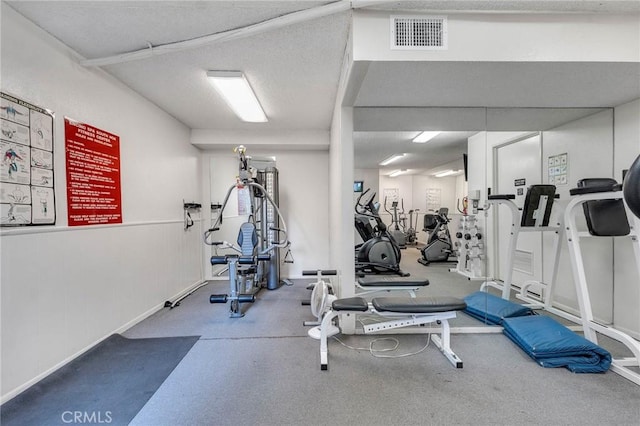 exercise area featuring a textured ceiling