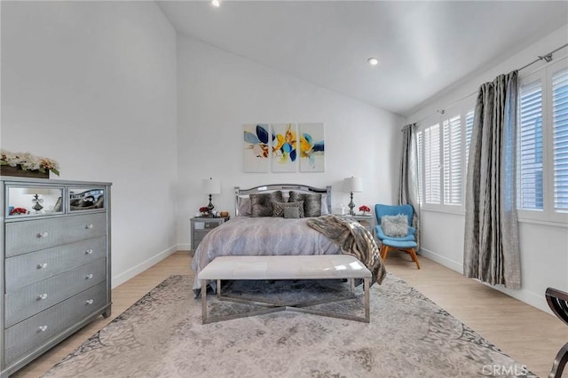 bedroom featuring vaulted ceiling and light wood-type flooring