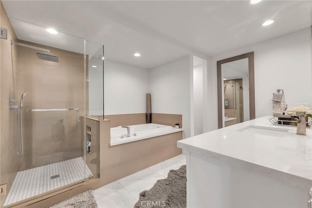 bathroom with vanity and shower with separate bathtub