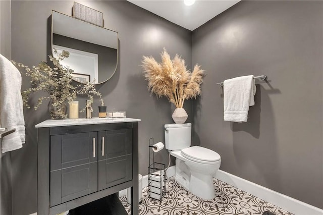 bathroom featuring toilet, vanity, and tile patterned floors