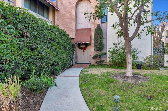 doorway to property with a yard