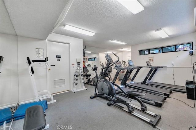 workout area featuring a textured ceiling