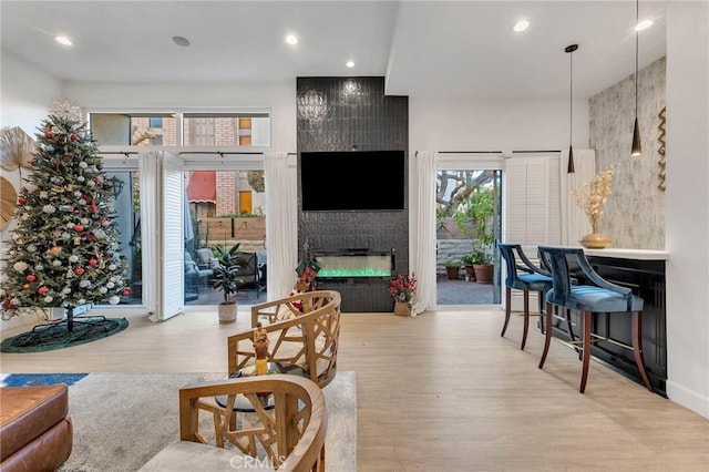 living room with light hardwood / wood-style floors and a tile fireplace