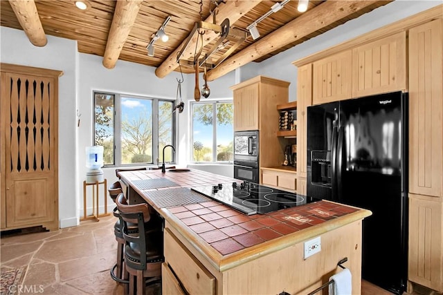 kitchen with tile countertops, wooden ceiling, sink, black appliances, and beamed ceiling