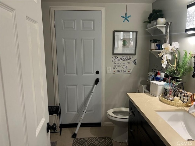 bathroom featuring tile patterned floors, vanity, and toilet