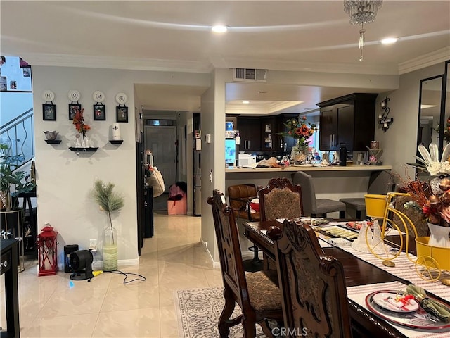 dining room featuring crown molding and light tile patterned flooring