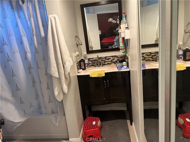 bathroom featuring tasteful backsplash, vanity, and shower / bath combination with curtain