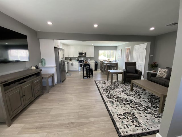 living room with light hardwood / wood-style flooring