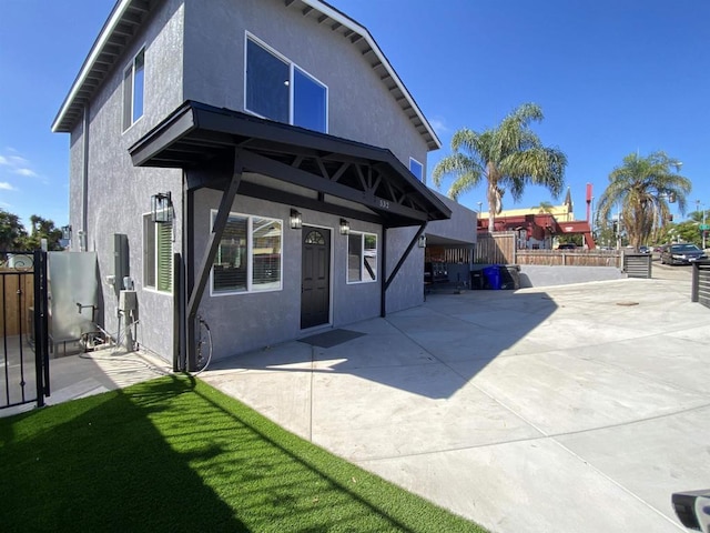 back of property with a patio