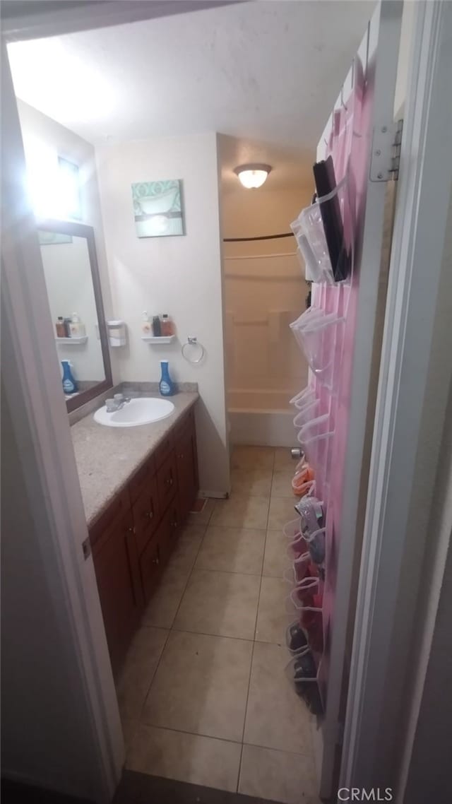 full bath featuring vanity and tile patterned floors