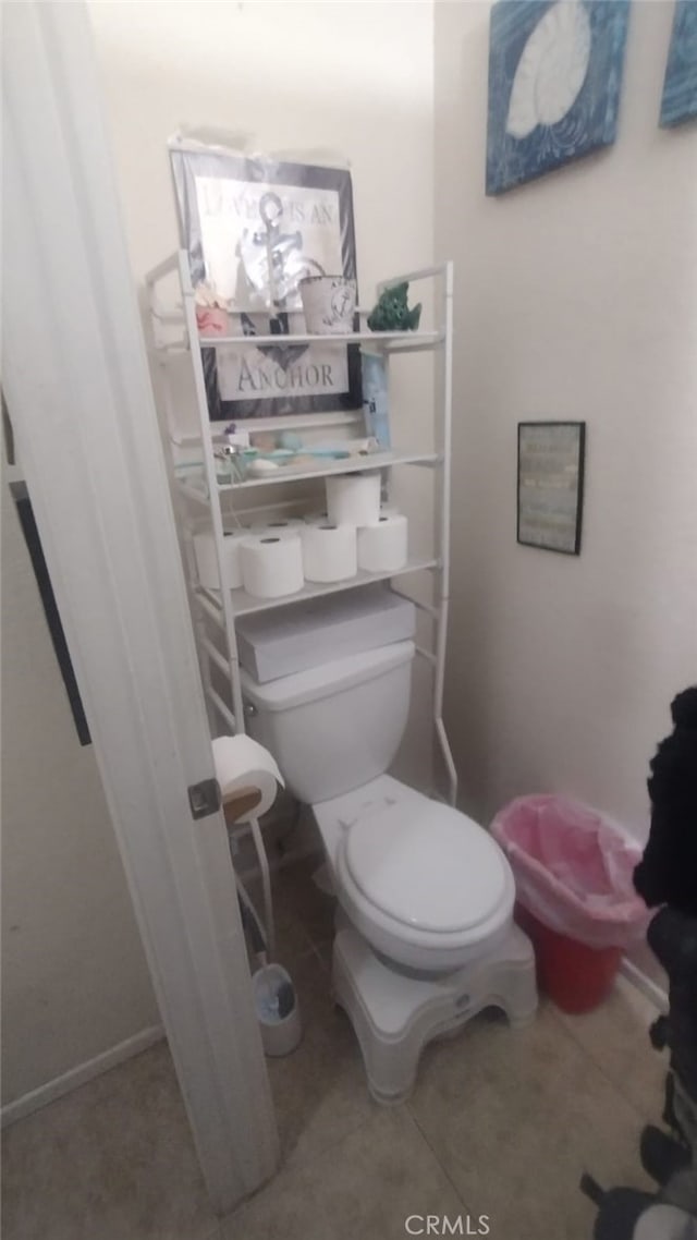 bathroom with tile patterned flooring and toilet