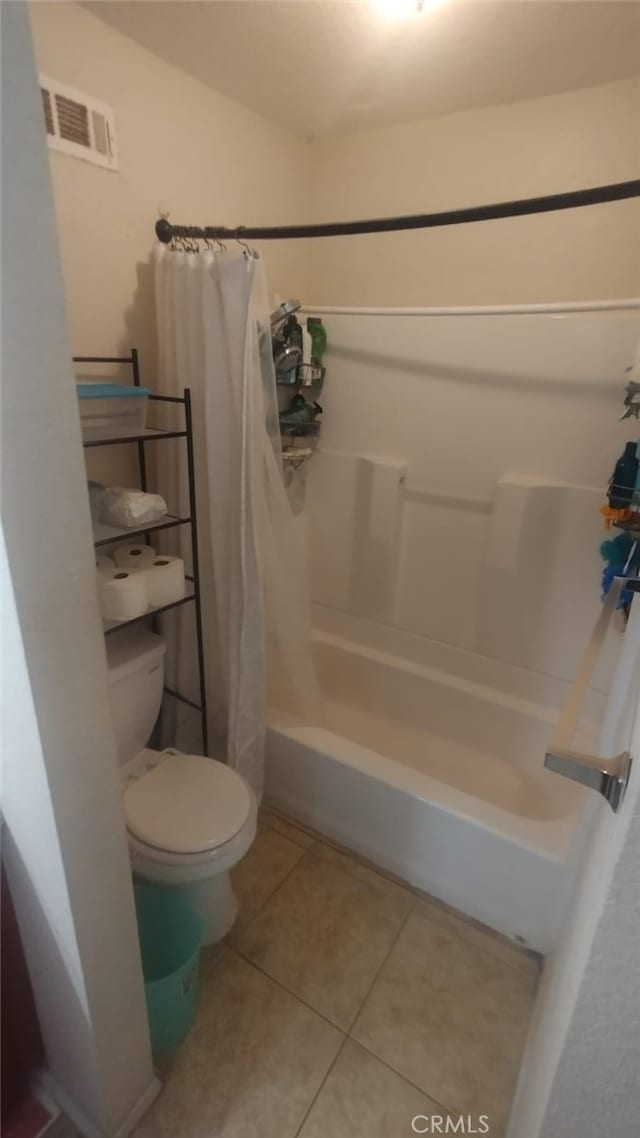 full bathroom featuring toilet, tile patterned flooring, visible vents, and shower / tub combo with curtain