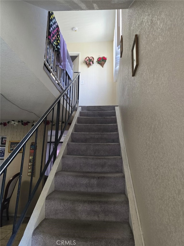 staircase with a textured wall