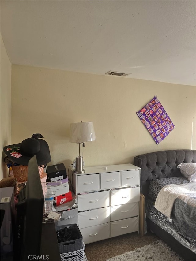 bedroom featuring carpet floors and visible vents