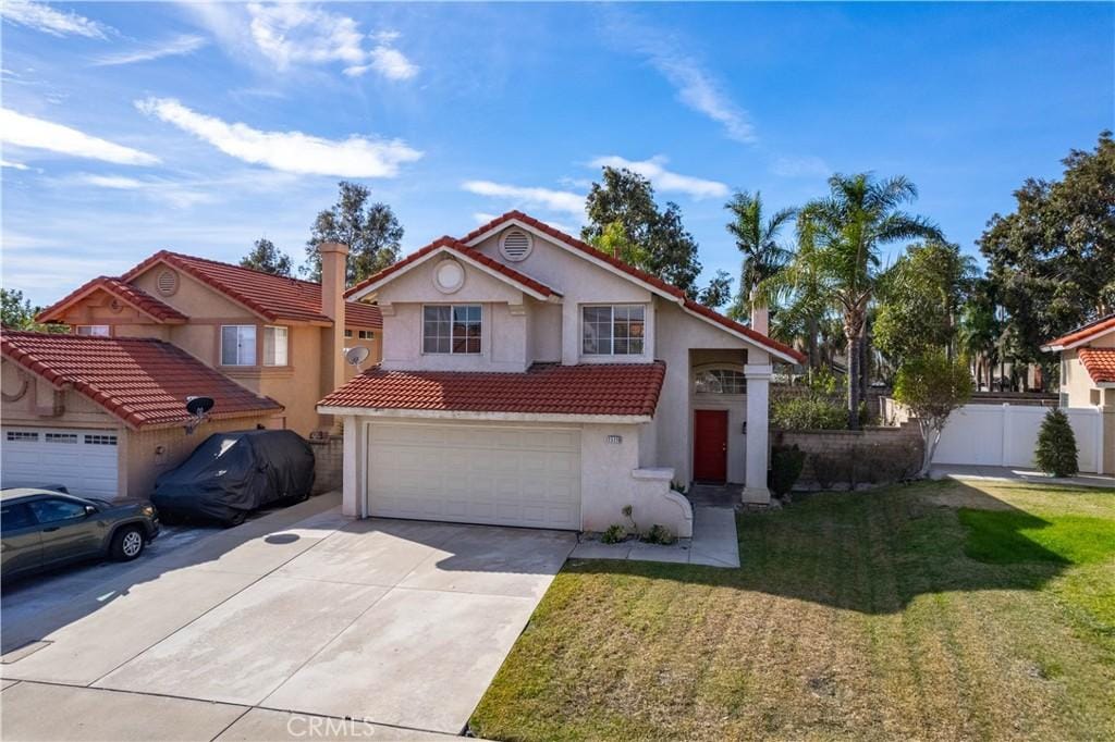 view of front of home with a garage and a front yard