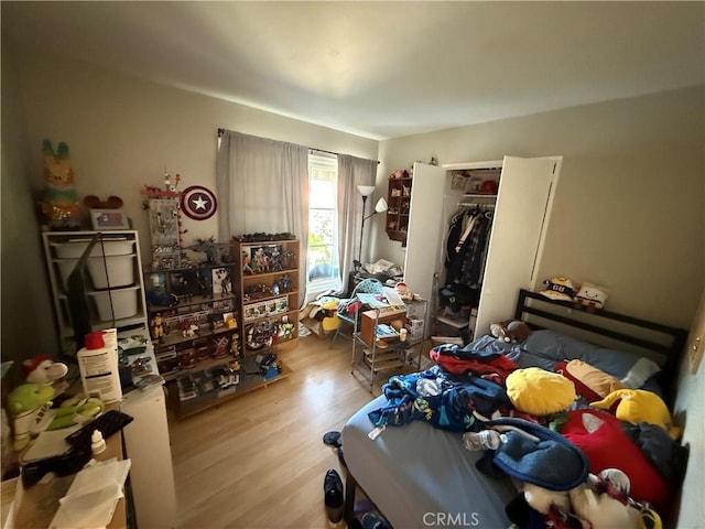 bedroom featuring a closet and light hardwood / wood-style flooring