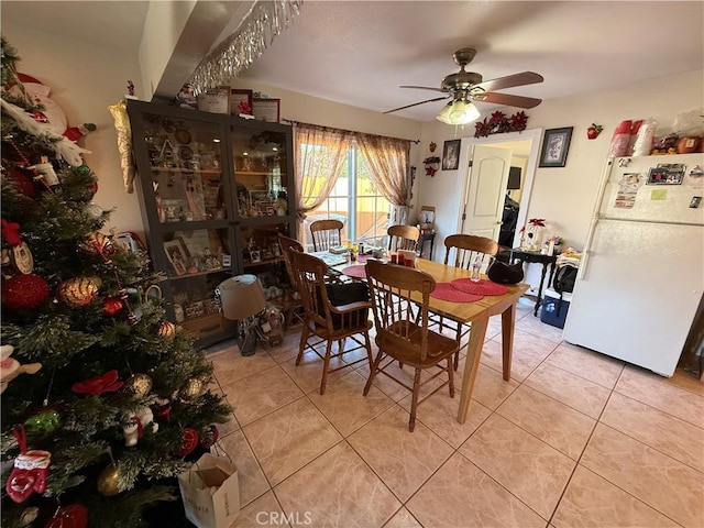 tiled dining room with ceiling fan