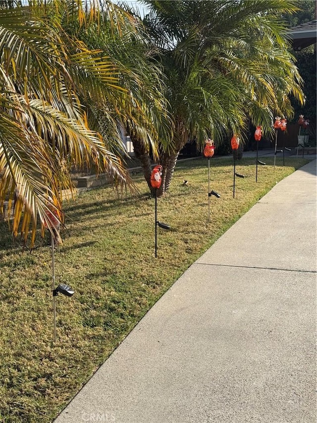 view of property's community with a lawn