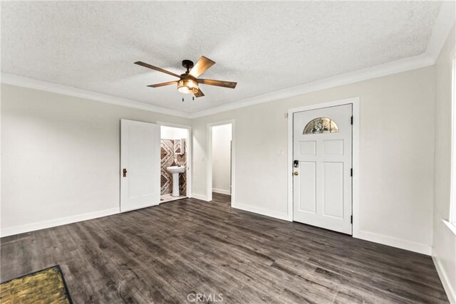 foyer with dark wood-type flooring, a textured ceiling, and crown molding