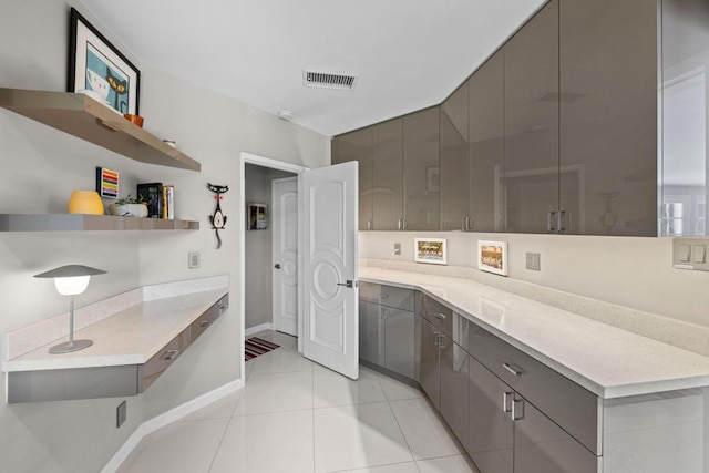 kitchen featuring light tile patterned floors and gray cabinetry